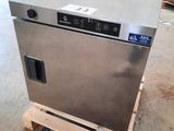 an image of a stainless steel dishwasher sitting on a pallet in a warehouse