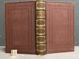 a brown book with a gold binding on it