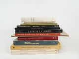 many books stacked on top of each other on a table