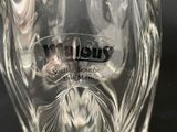 a clear glass vase with a black label on it