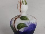 a small vase with a flower on it on a table