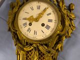 a gold clock on a white sheet with a blue background