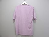 purple t - shirt hanging on a hanger against a white wall