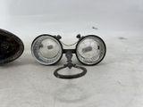 a pair of glasses sitting on the ground next to a pair of scissors