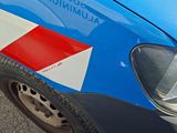 a close up of a blue car with red and white stripes