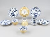 a group of blue and white plates and bowls on a table
