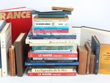 many books stacked on top of each other on a table