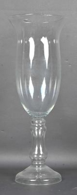 a glass that is sitting on a table in front of a wall