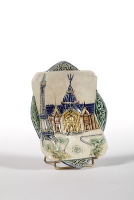 a small vase with a picture of a building on it