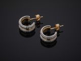 a pair of diamond hoop earrings on a black surface
