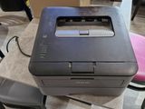a printer sitting on top of a desk next to a chair