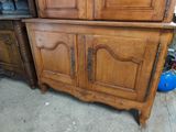 a wooden cabinet with a door on top of it