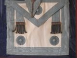 a picture of a blue and white apron with a cross on it