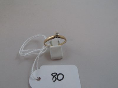 a white tag with a gold ring on it and a white tag with a gold ring on it