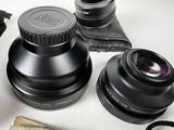 a camera lens, a camera case, and some other items on a table