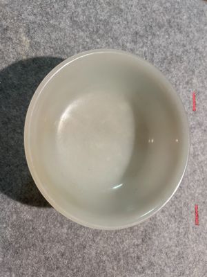 a white bowl sitting on a table with a measuring line