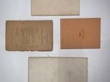 three pieces of old papers are sitting on a white surface
