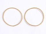 a pair of gold hoop earrings on a white background