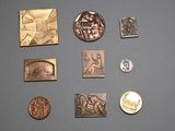 many different types of coins on display on a table