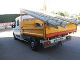 a yellow truck with a ladder on the back of it