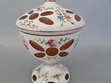 a white bowl with a brown and white design on it