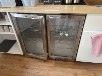 two refrigerators that are on the counter in the kitchen