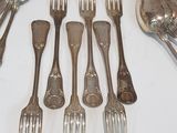 a lot of forks and spoons that are on the table