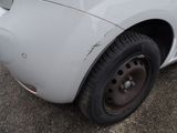 a close up of a white car with a flat tire