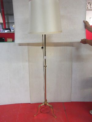 a man standing next to a lamp on a table