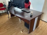 a desk with a computer monitor and a keyboard on it