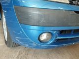 a close up of a blue car in a garage