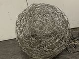 a ball of wire sitting on the floor next to a pair of scissors