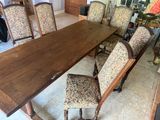 a large wooden table with many chairs around it