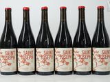 six bottles of wine are lined up on a table