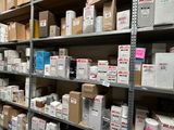 boxes are stacked on a shelf in a warehouse with shelves full of boxes