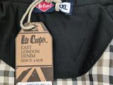 a label on the back of a black and white checkered shirt