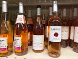 bottles of wine are lined up on a shelf in a store