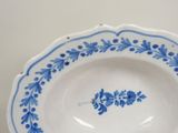 a blue and white plate with a flower design on it