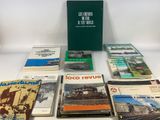 several books are sitting on a white table with a green box