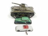 a toy tank and a car next to a keychain