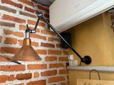 a wall mounted air conditioner mounted on the side of a brick wall