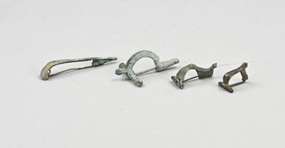 trois pièces métalliques sont représentées sur une surface blanche