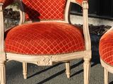 pair of red and white chairs sitting in front of a black door
