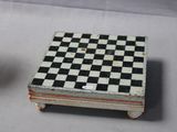 a small black and white checkered box next to a small black and white checkerboard box