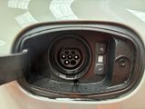 a close up of a car ' s fuel tank with a power cord attached to it