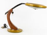 a close up of a lamp on a wooden stand with a key