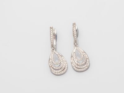 a pair of diamond earrings on a white background