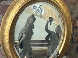 a picture of a reflection of a man and a woman in a mirror