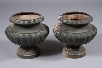 two vases sitting next to each other on a table