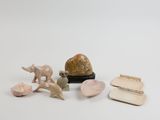 a small collection of animal figurines sitting on a table